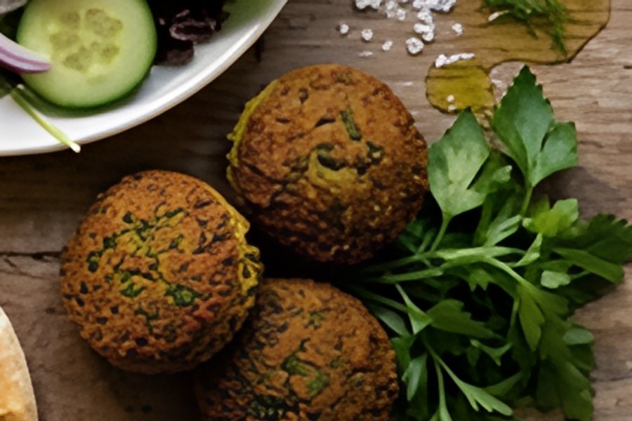 A close-up of falafel and parsley on a wooden table, upscaled with AI