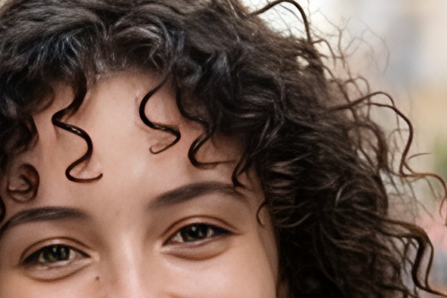 A close-up of a smiling woman's face, upscaled with AI